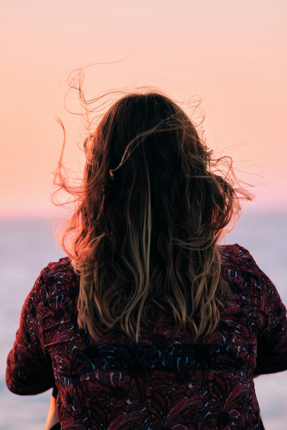 a woman with her hair blowing in the wind