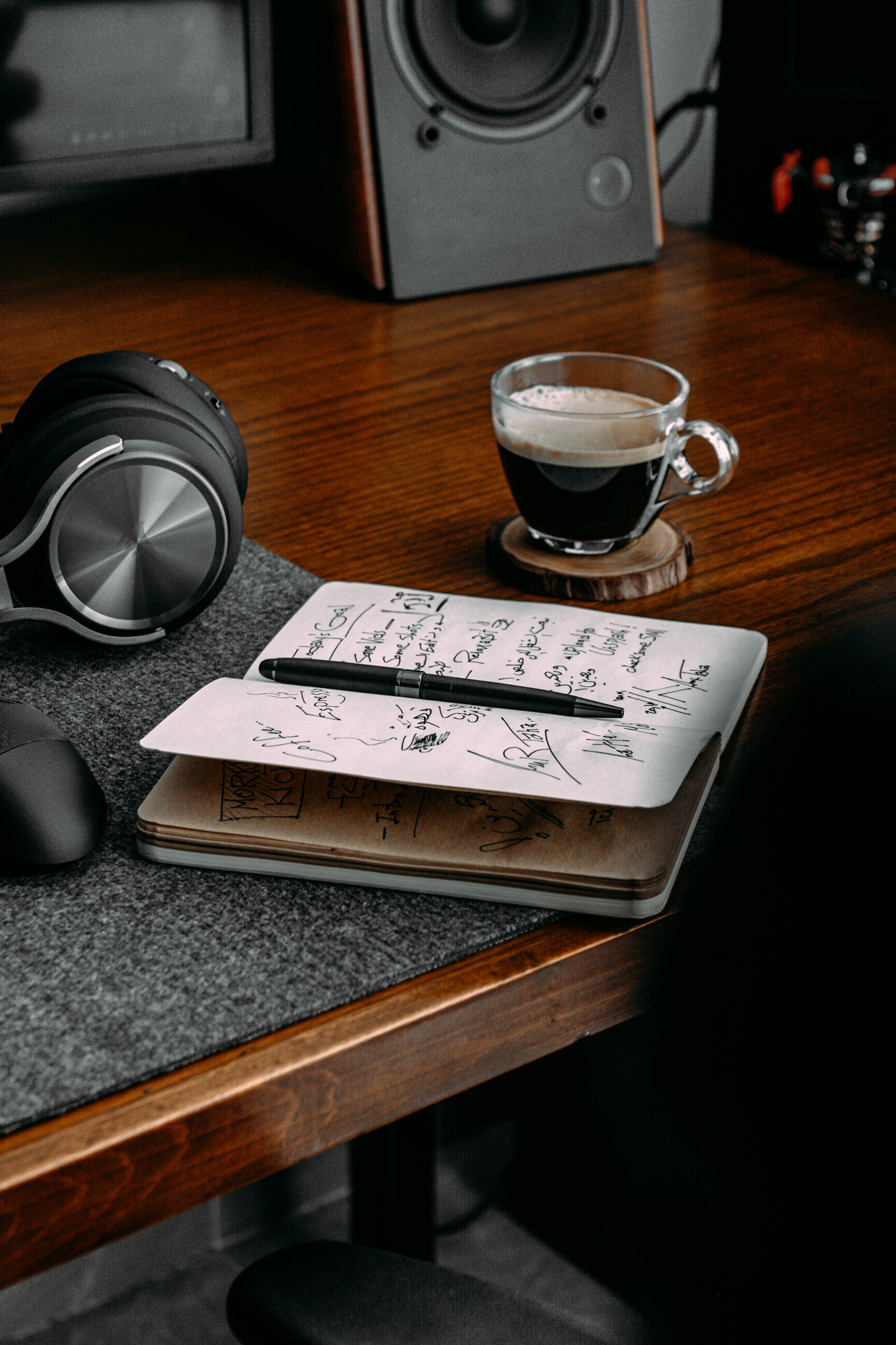 a glass of liquid on a coaster
