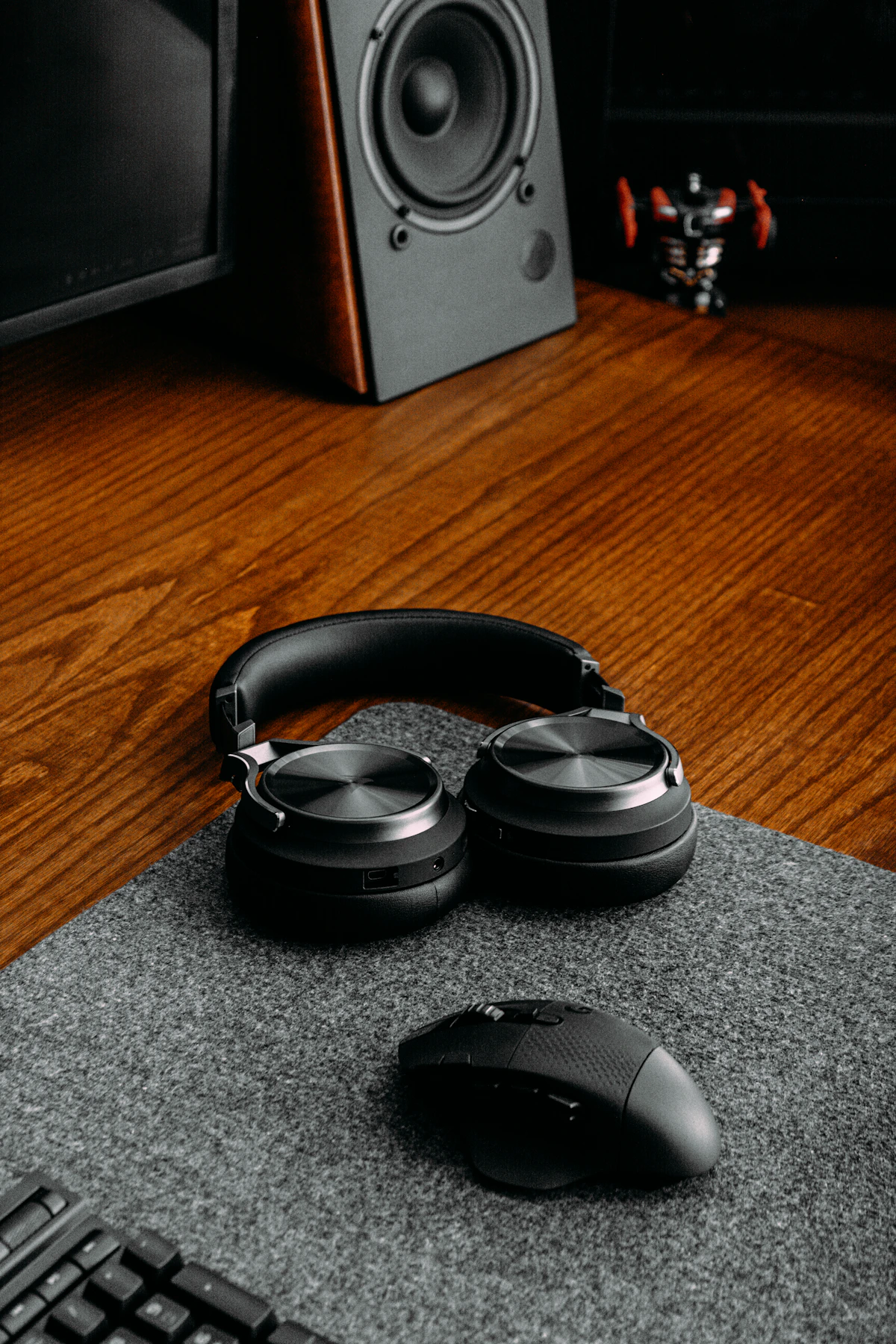 Wireless headphones and computer accessories displayed on a premium desktop setup
