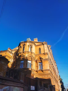 An aged historical building carefully restored, bathed in warm afternoon light