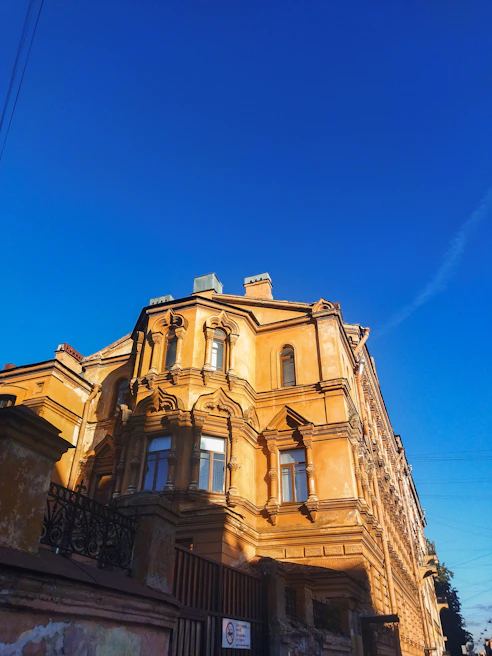 An aged historical building carefully restored, bathed in warm afternoon light