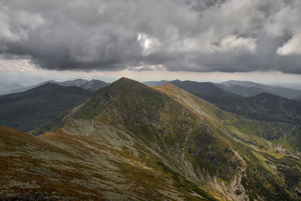 a landscape with mountains and clouds