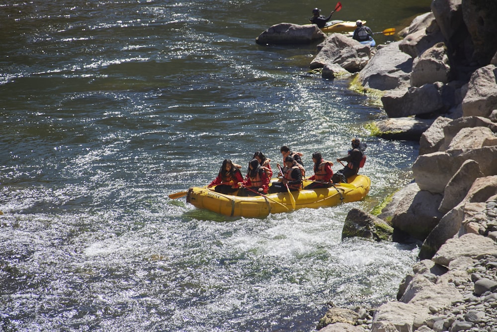 a group of people in a yellow canoe on a river