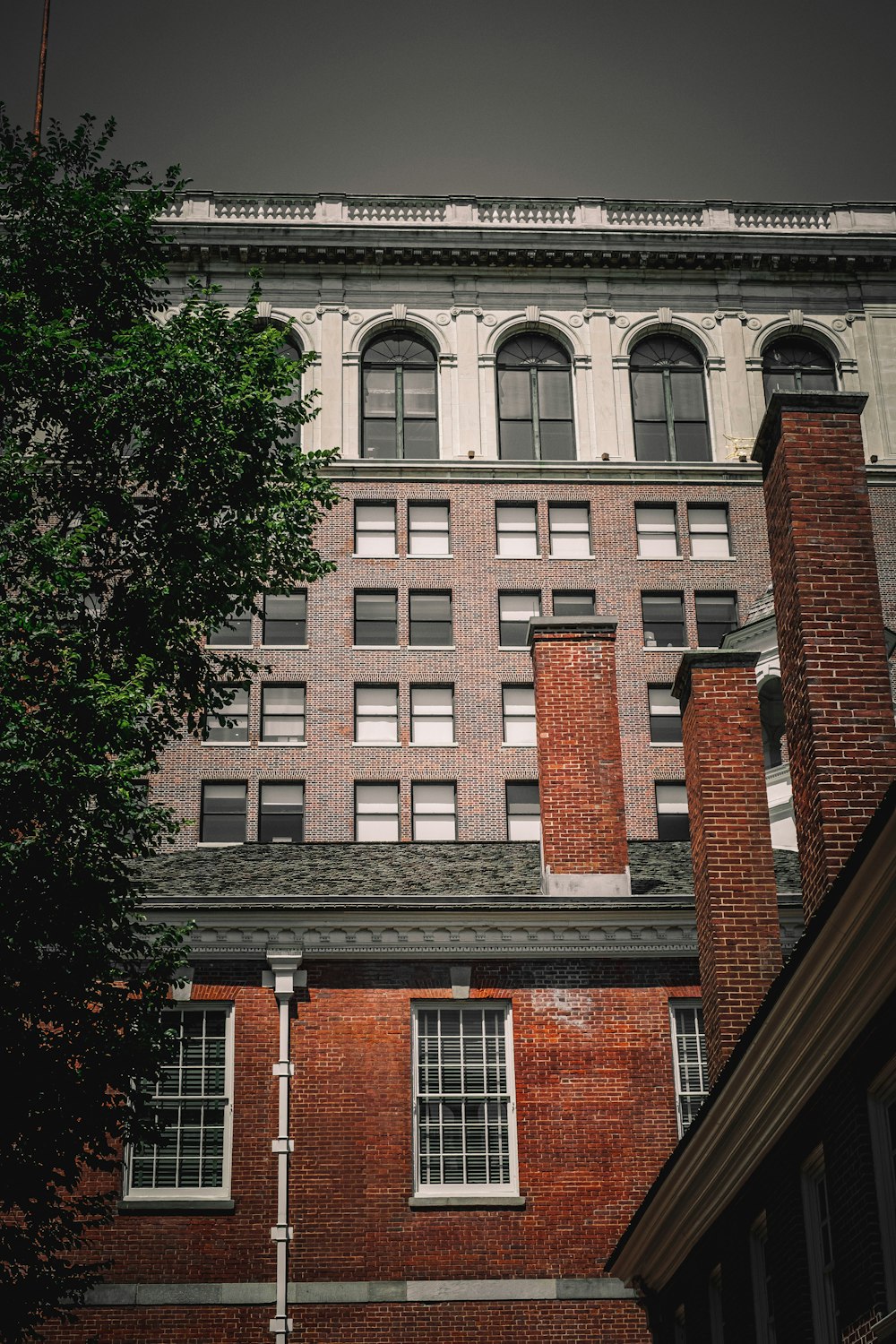 a brick building with a tree in front of it