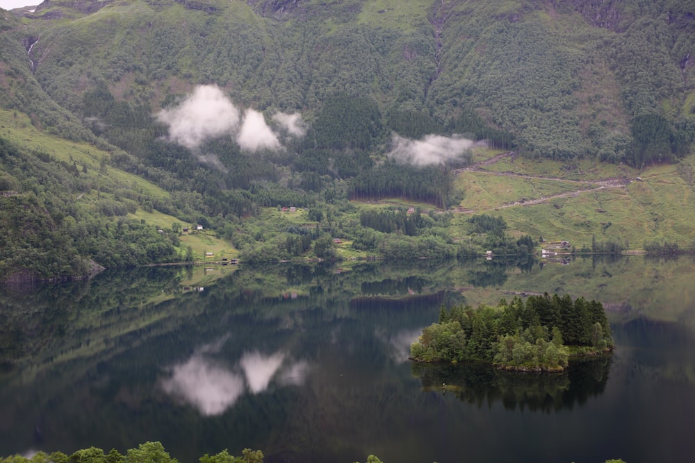 a lake surrounded by hills and trees