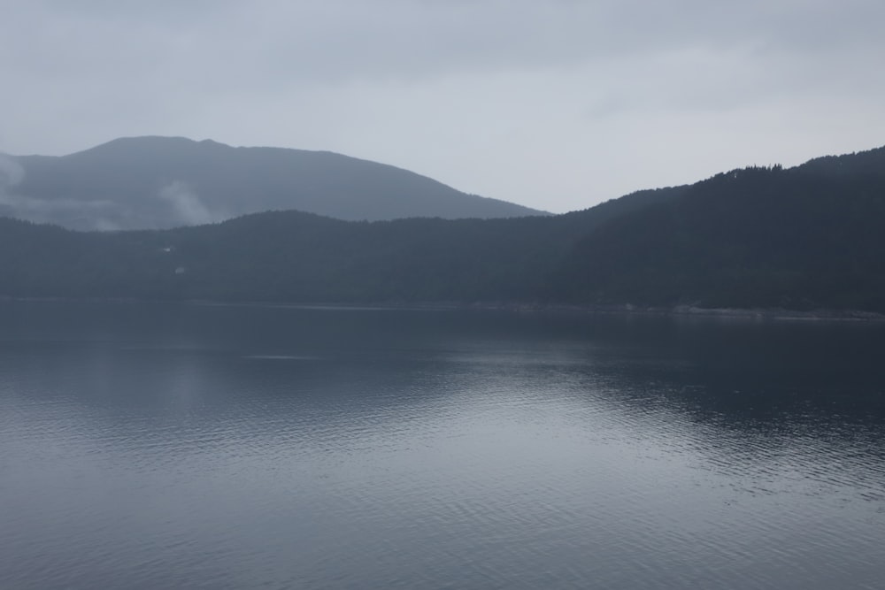 a body of water with mountains in the background