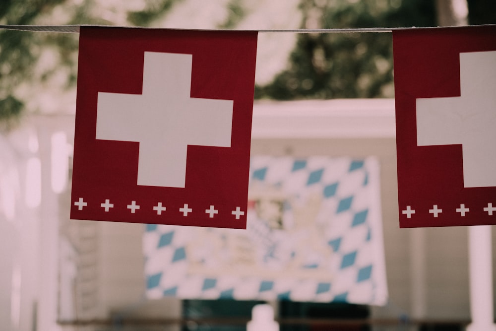 a flag with a red and white cross and a white star