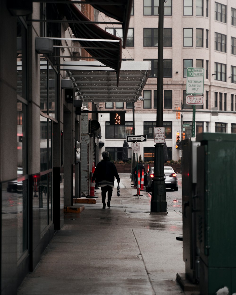 a person walking down a sidewalk