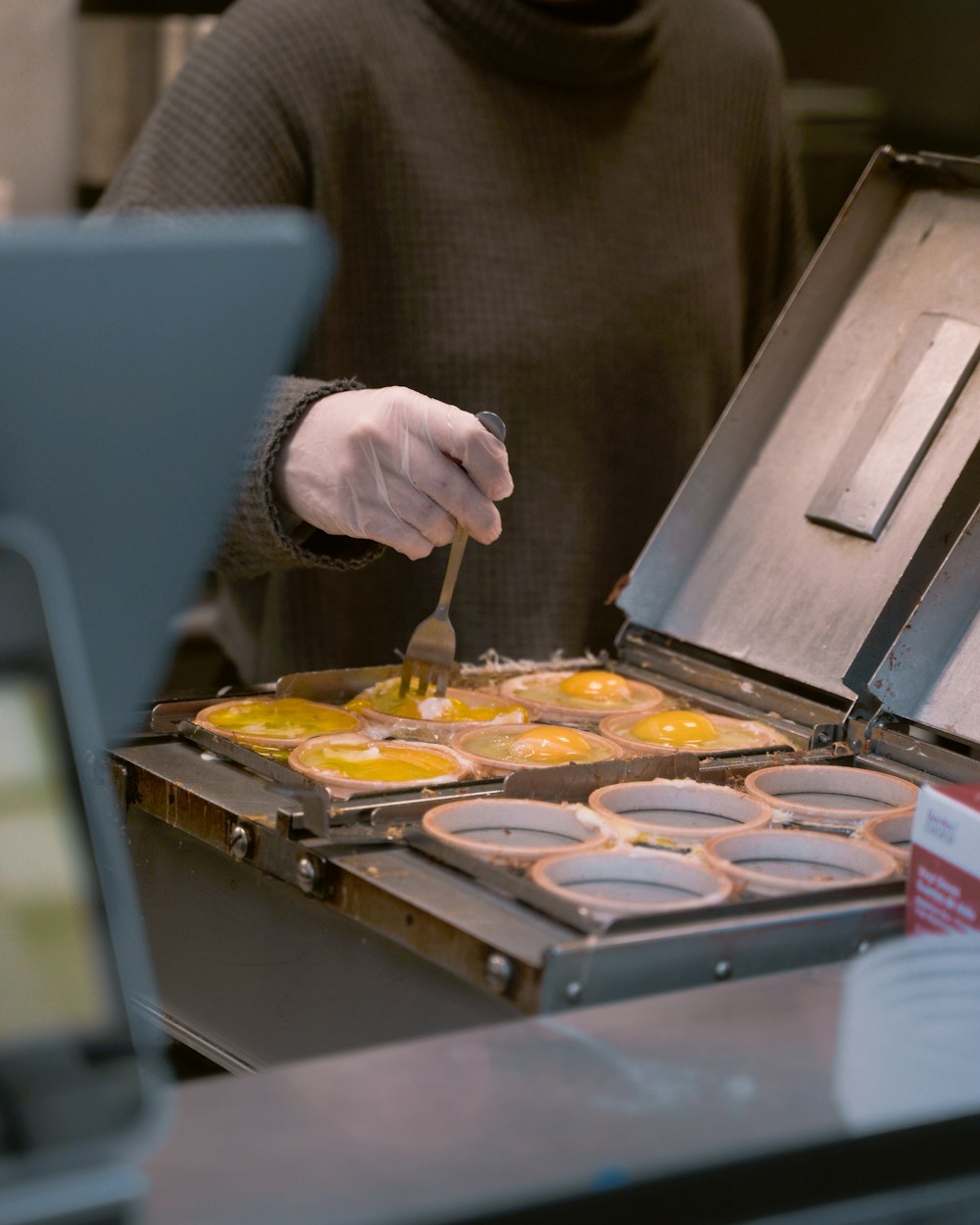 a person putting a pizza in a box