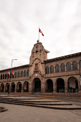 a building with flags on the roof