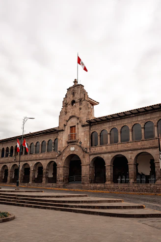 a building with flags on the roof