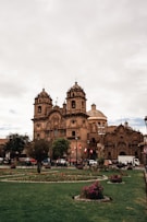 a large building with a green lawn