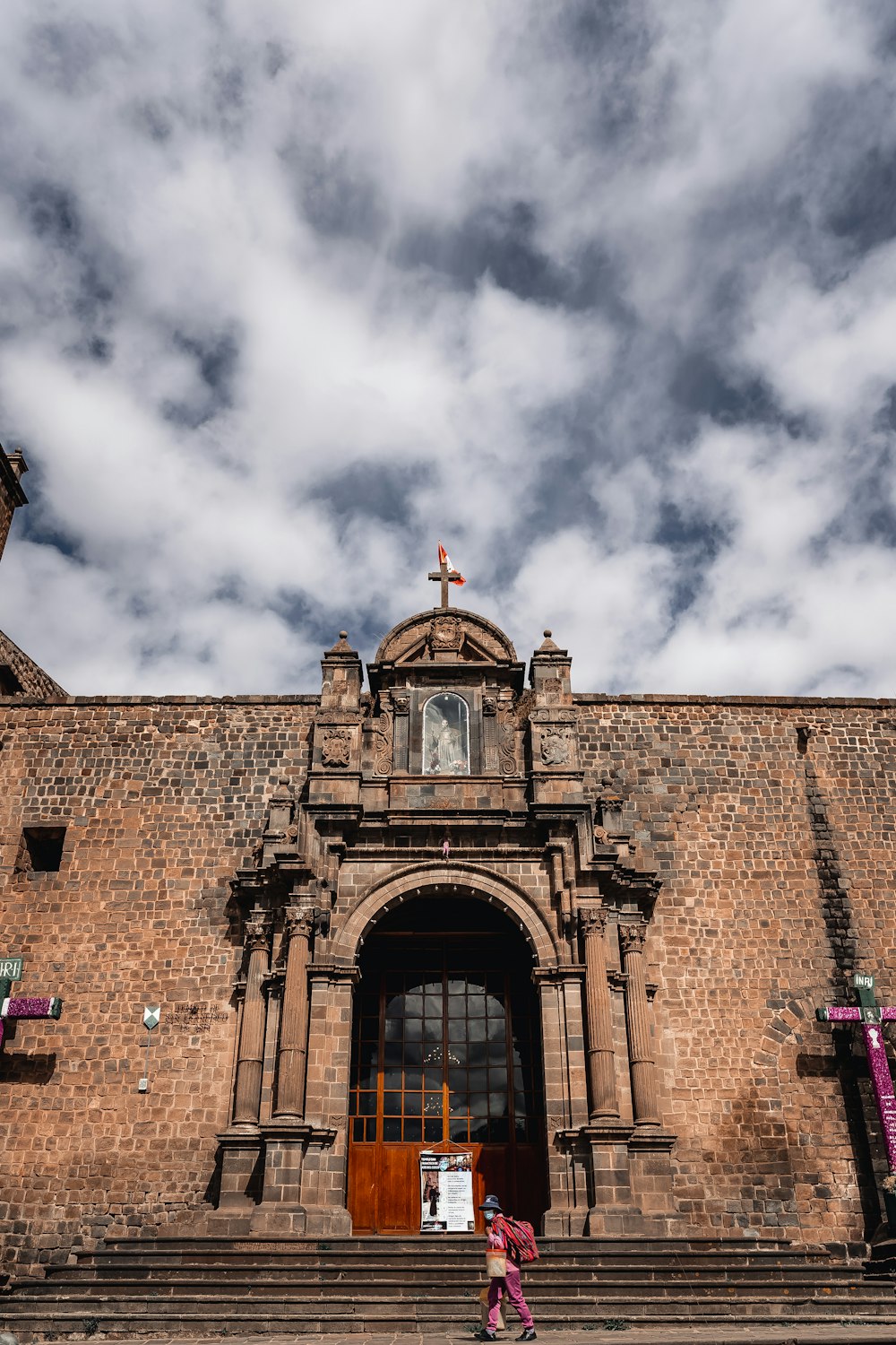 a girl standing on stairs outside a building with a cross on top