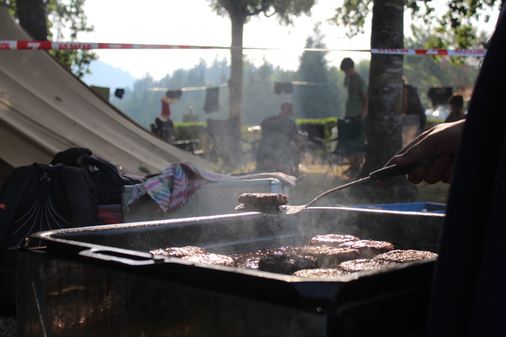 a person cooking food on a grill