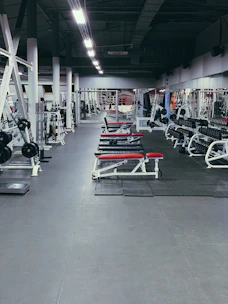 Close-up of a clean gym carpet with workout equipment in the background.