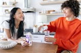 A user interacting with the hydration bot in a modern kitchen.