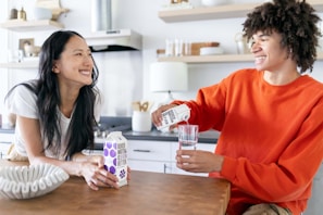 A user interacting with the hydration bot in a modern kitchen.
