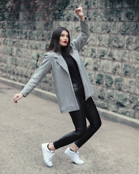 A stylish urban model wearing essenstyle streetwear against a minimalist gray background.