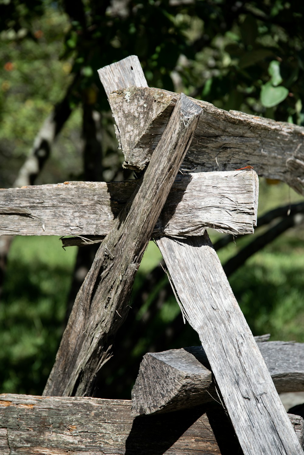 a wooden cross on a wooden fence