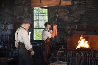 a couple of men working in a brick room with a fire