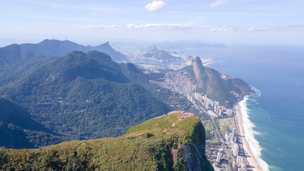 a large mountain with a body of water below