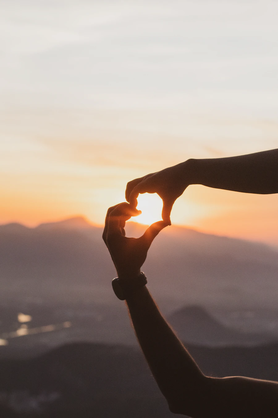 A hand reaching out toward the open sky