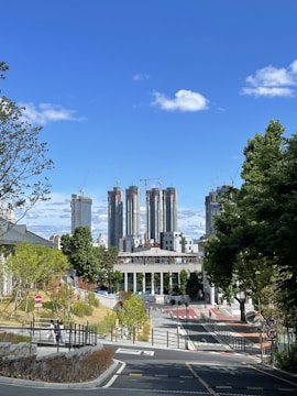 Engineers coordinating infrastructure plans on site with urban skyline in background.