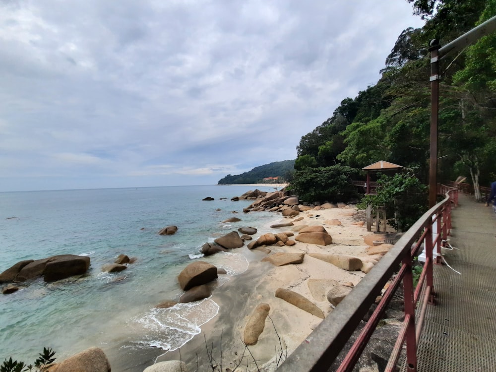 a rocky beach with a walkway
