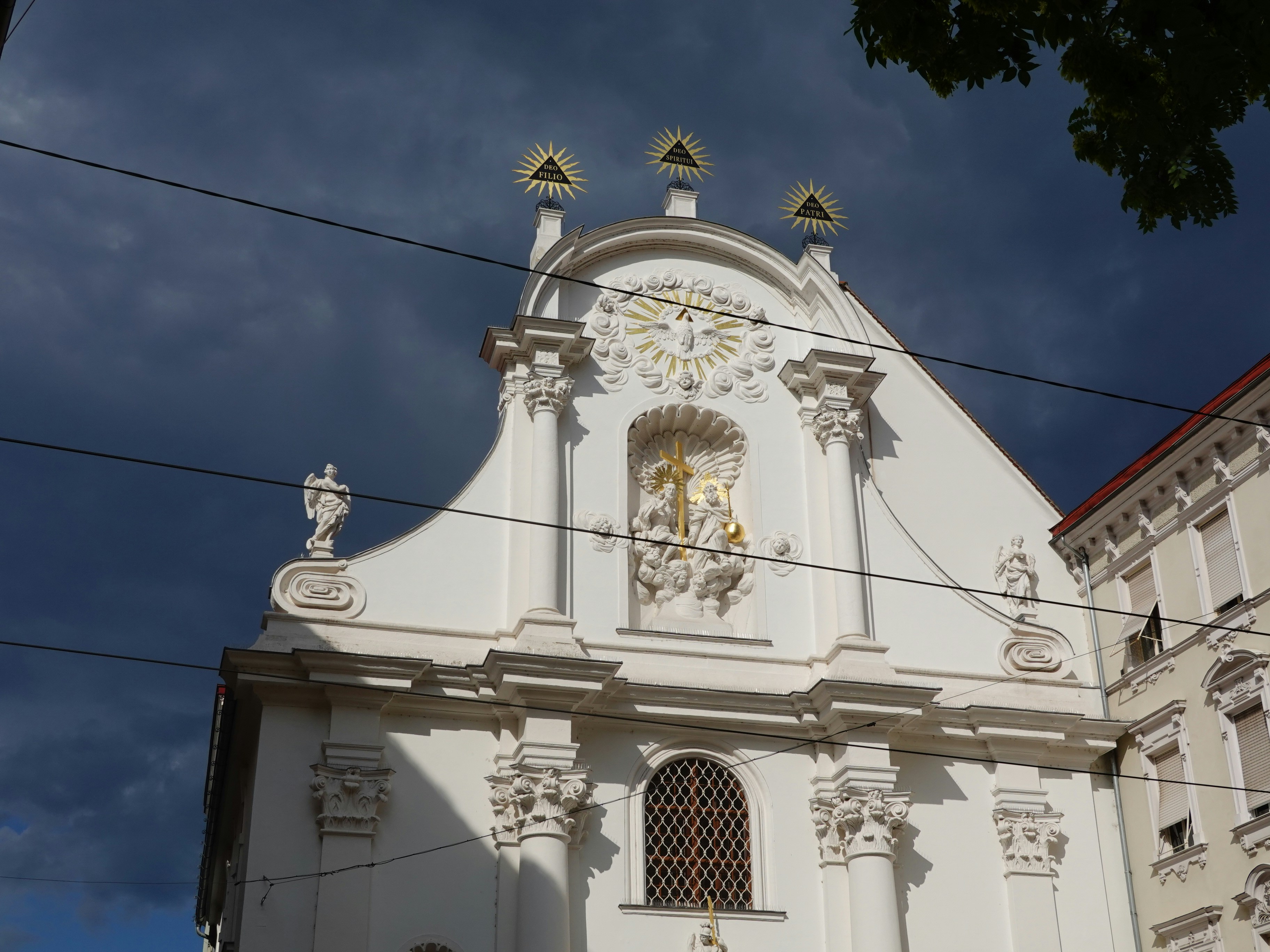 a white building with a gold cross on top, 