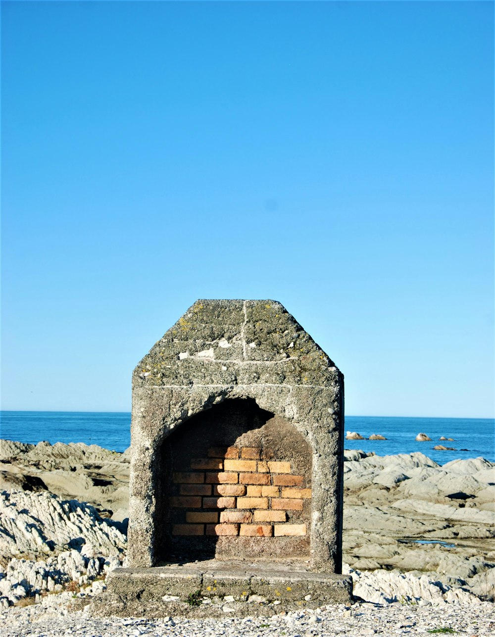 a brick chimney on a beach
