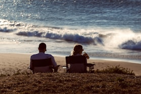 a couple sitting on a beach