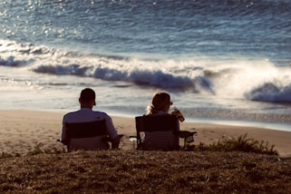 a couple sitting on a beach