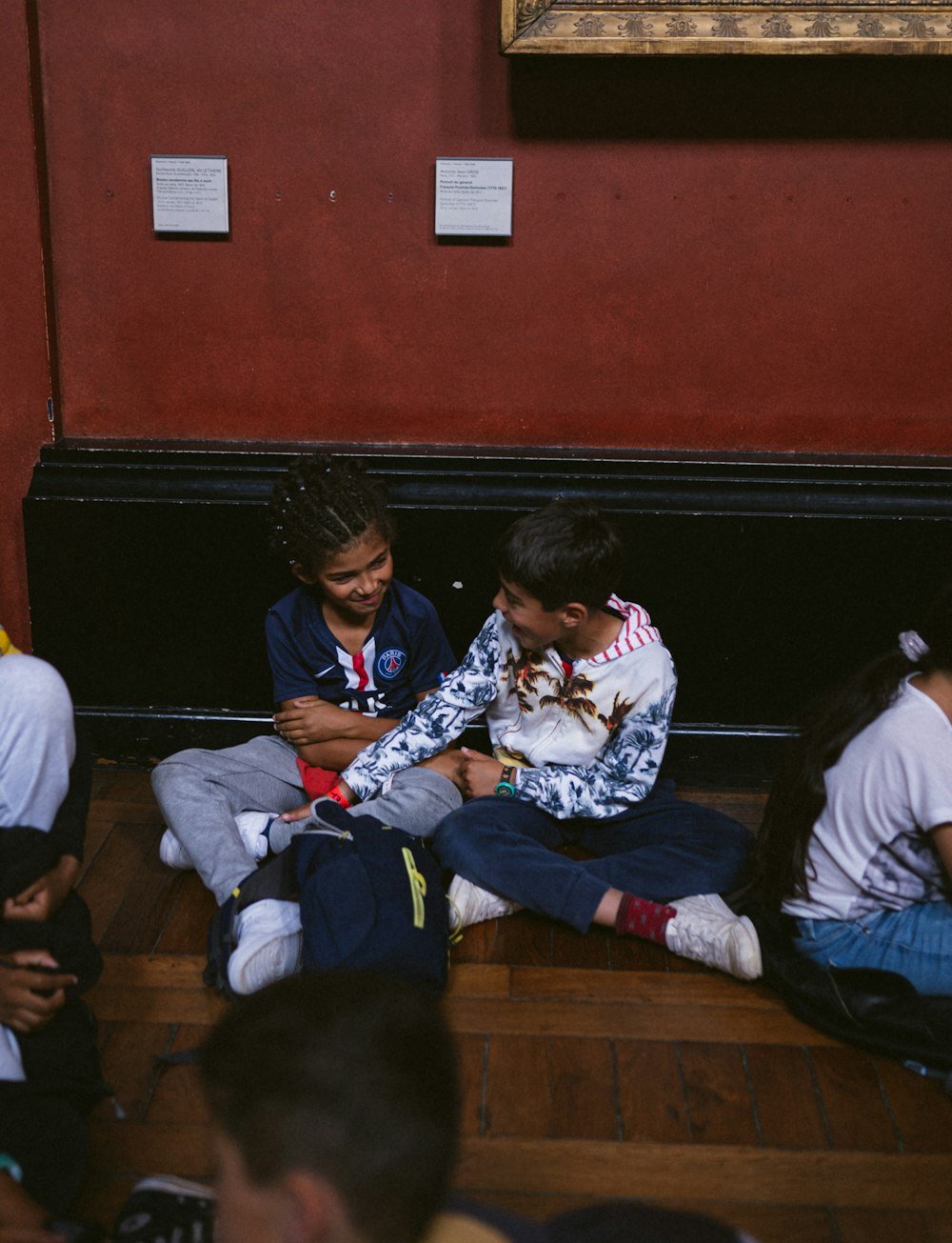 a group of boys sitting on a bench