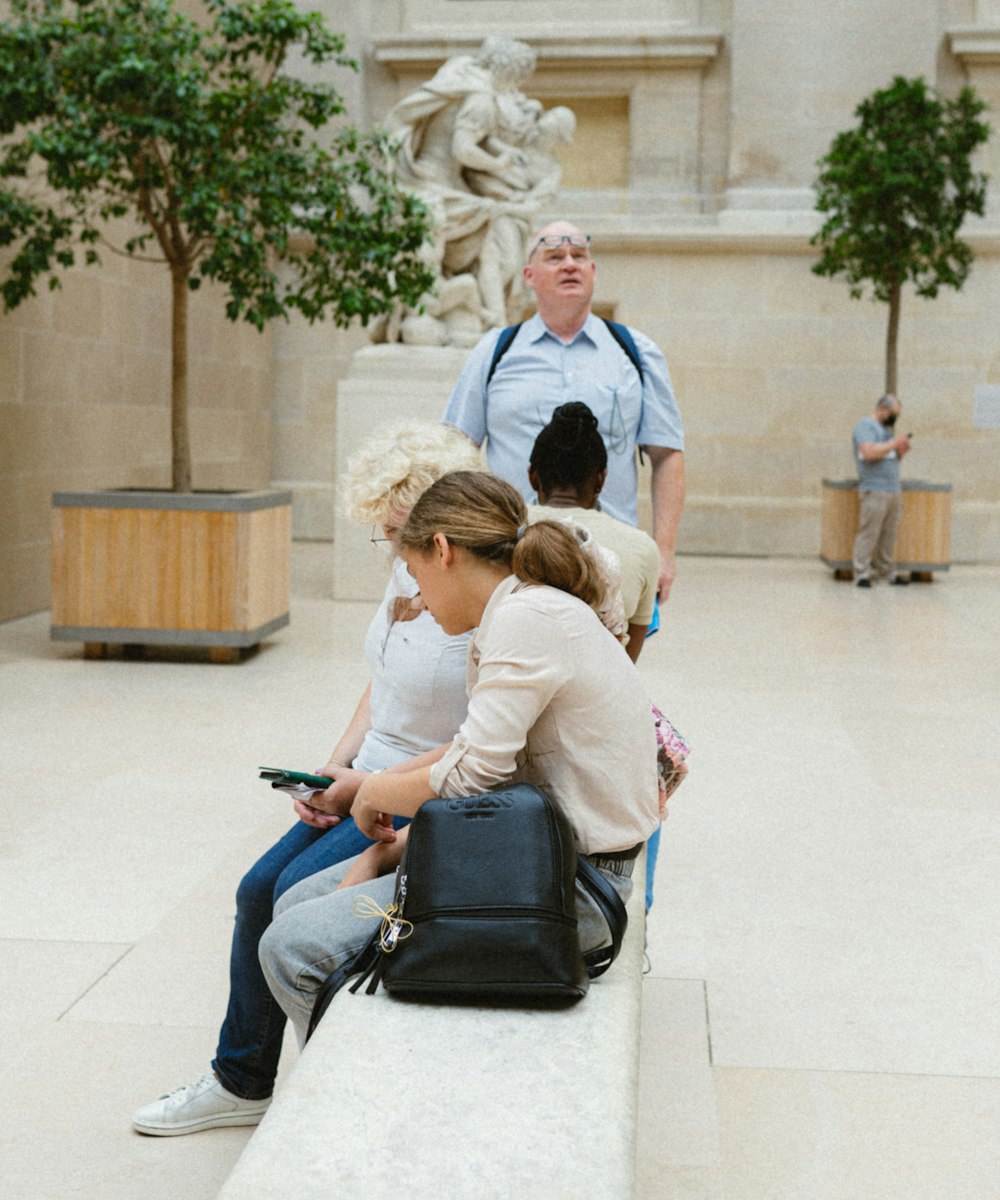 a group of people sitting on a bench