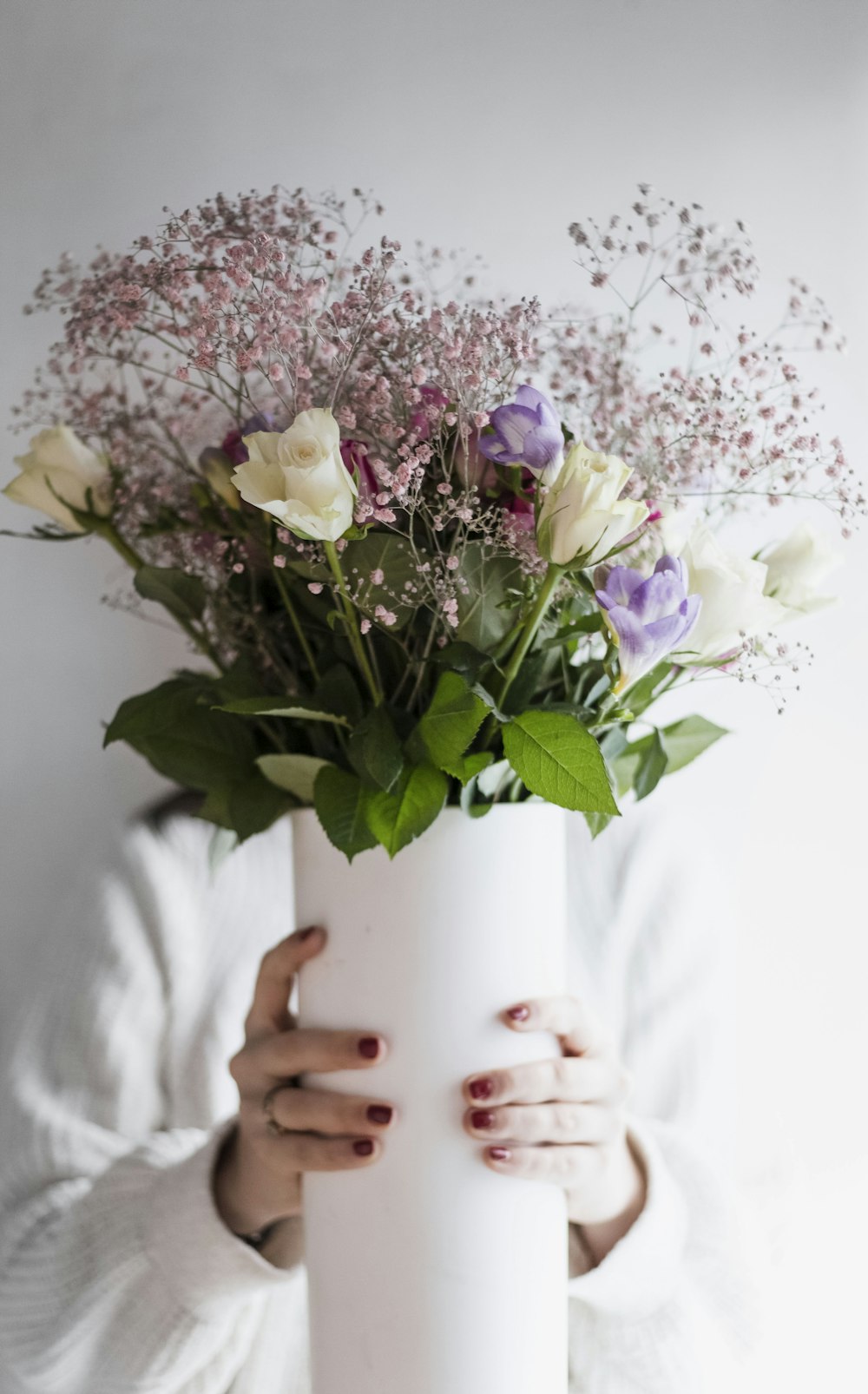 a person holding a bouquet of flowers