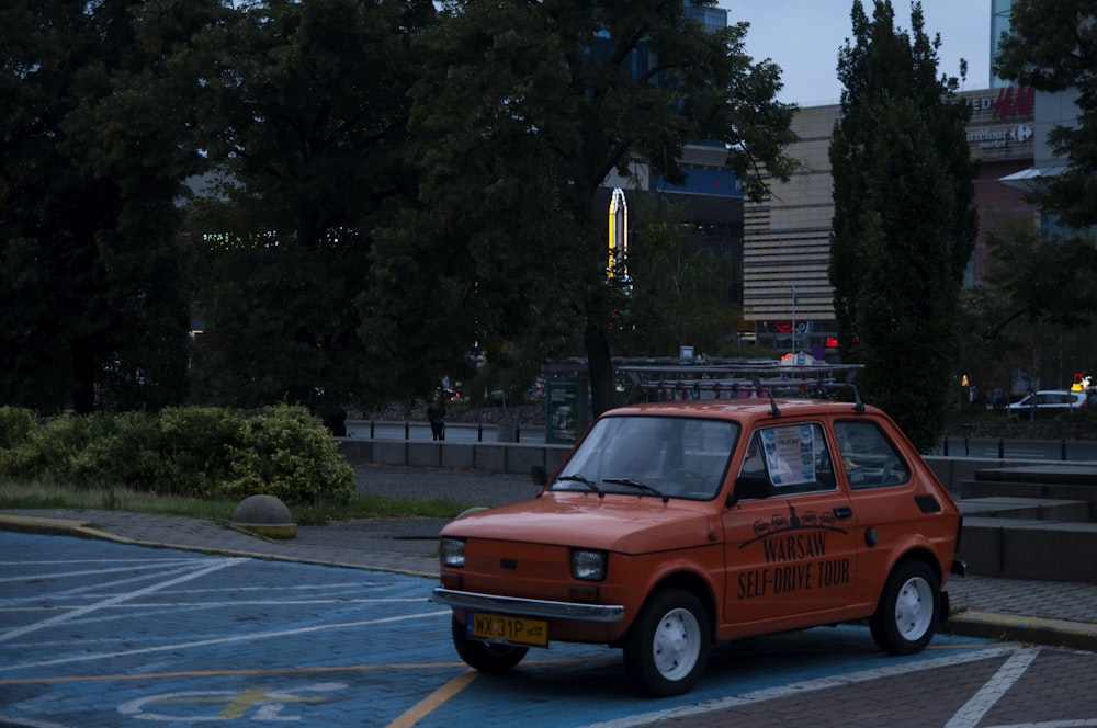 an orange car on a street