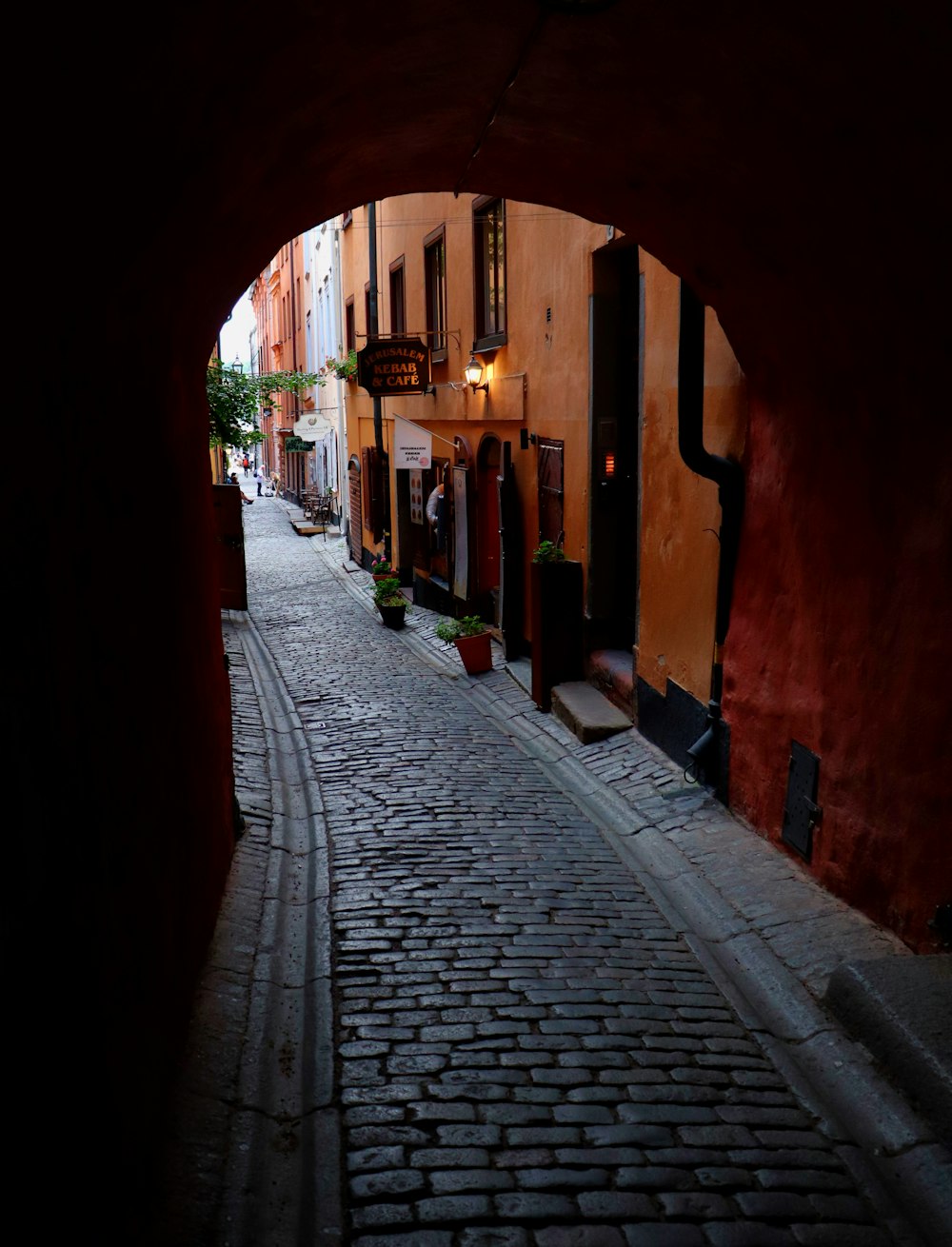 a cobblestone street with buildings on either side of it