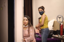 Behind-the-scenes shot of influencers preparing makeup and styling in a luxurious dressing room.