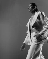 A video still of a client confidently walking in a tailored look after a visagism session.