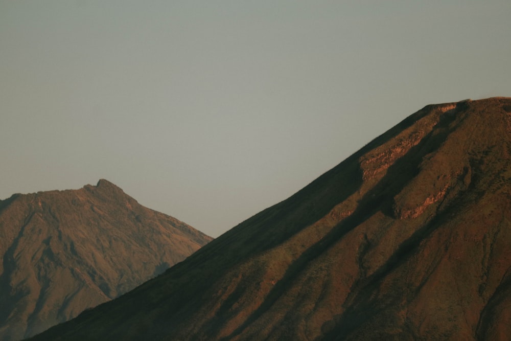 a rocky mountain with a valley below