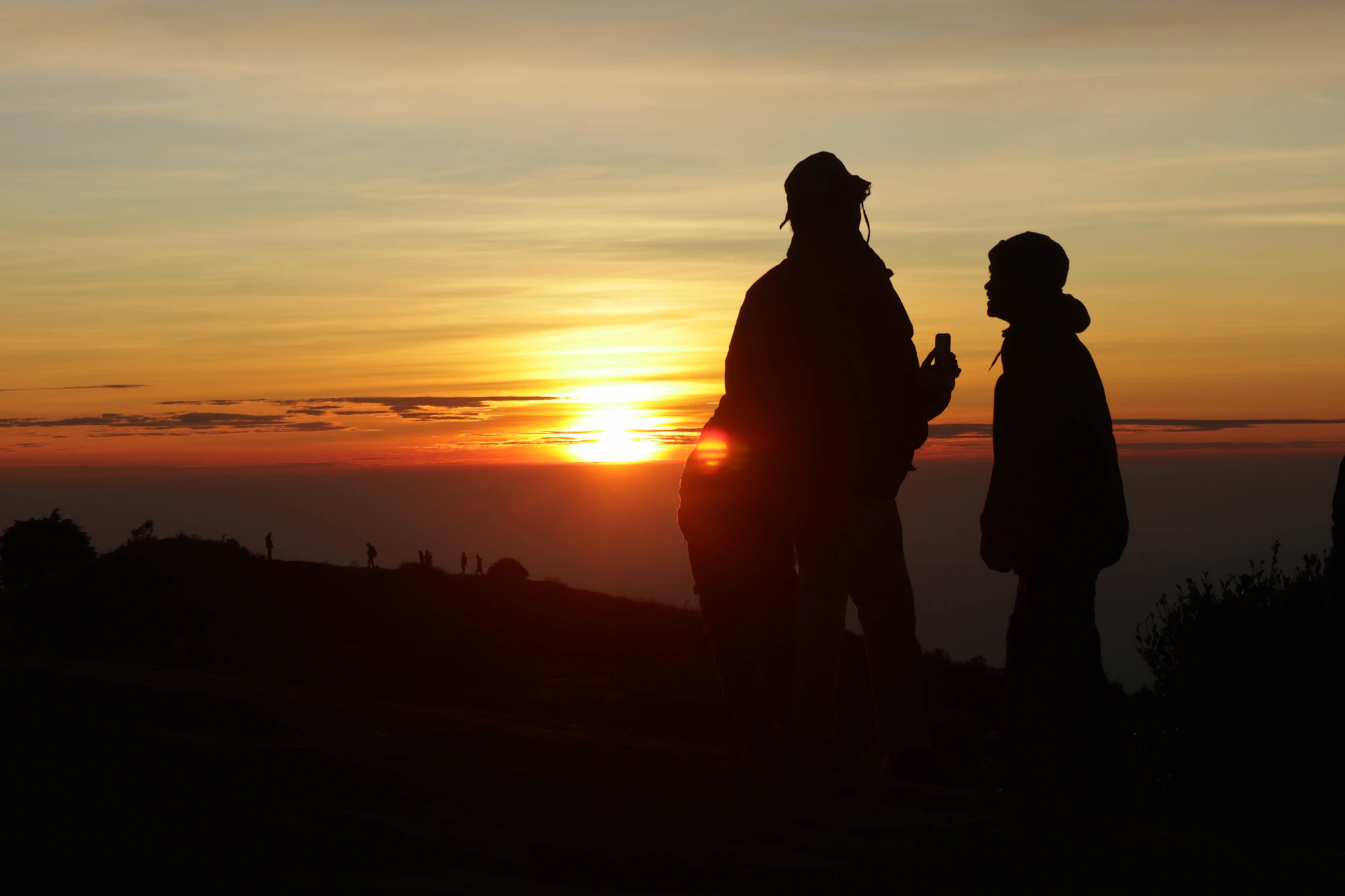 A parent and child together at sunset