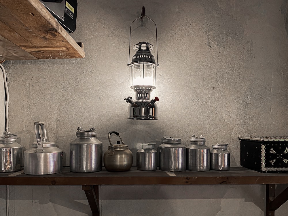 a group of metal pots on a shelf