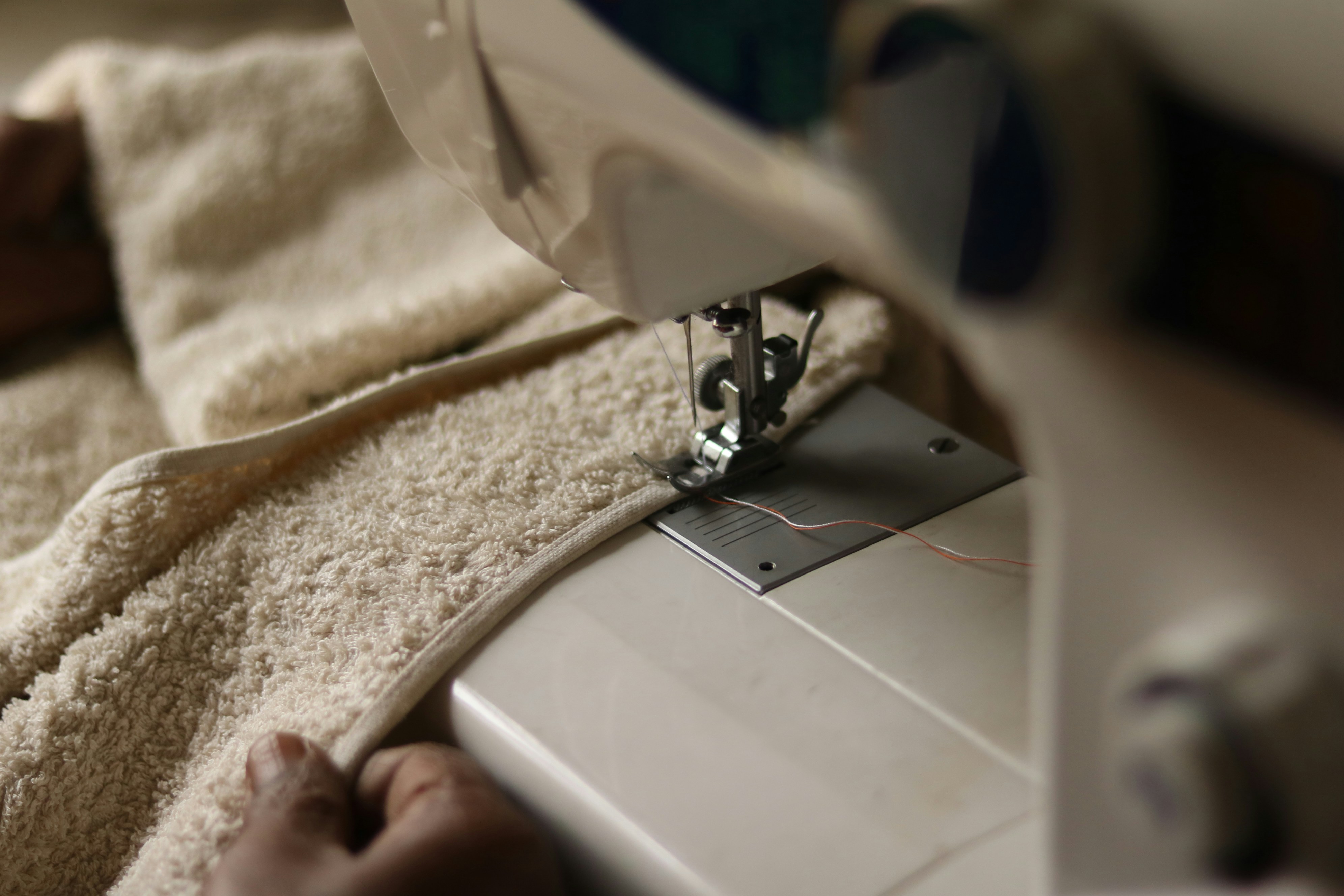 a hand holding a white device