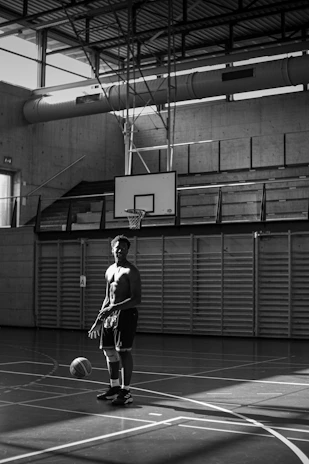 A vibrant photo of a basketball and racket leaning against a locker in a student gym.