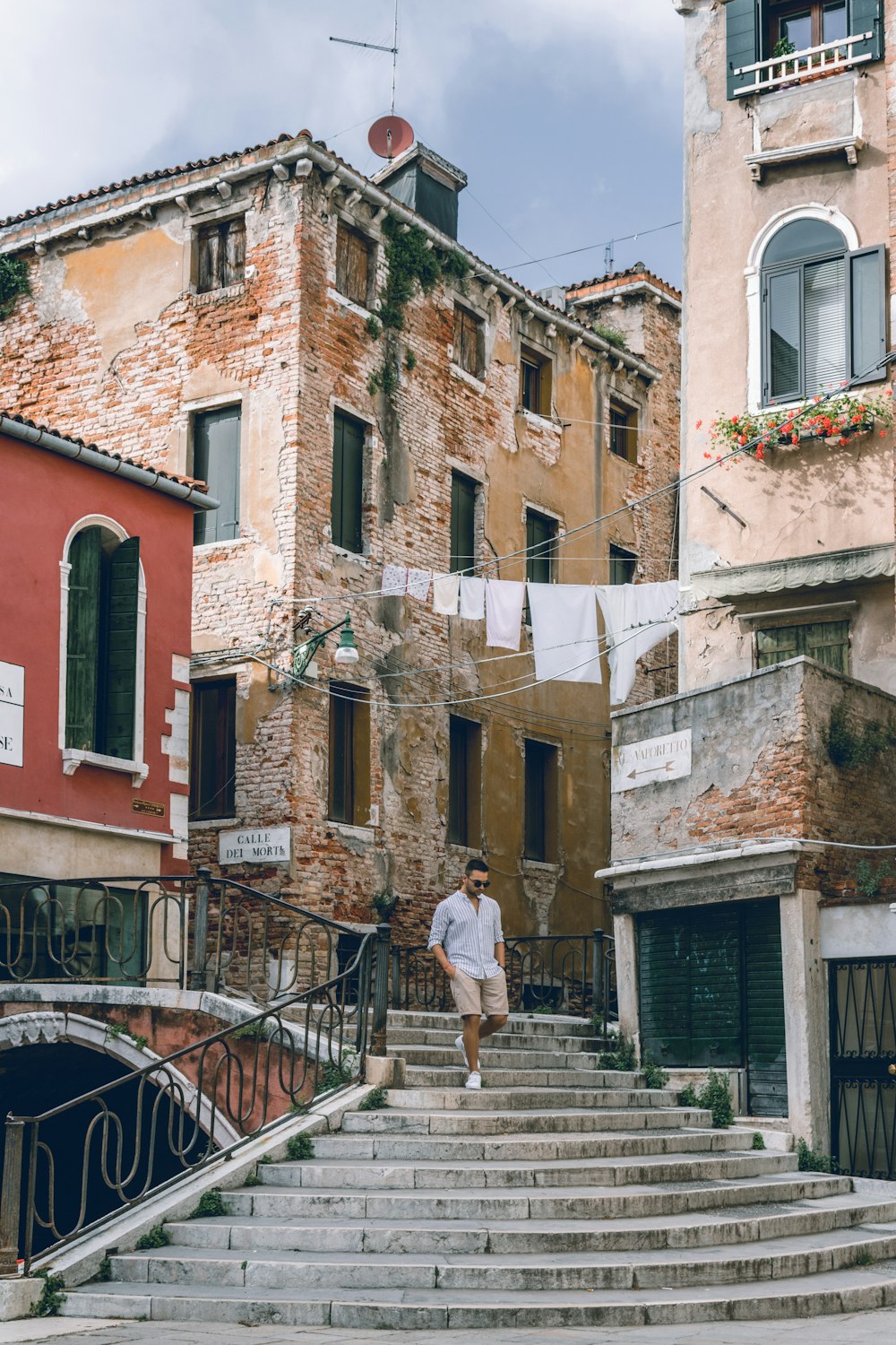 a person walking up a set of stairs between two buildings