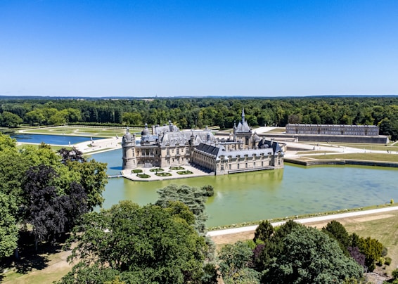 a castle on a hill by a river