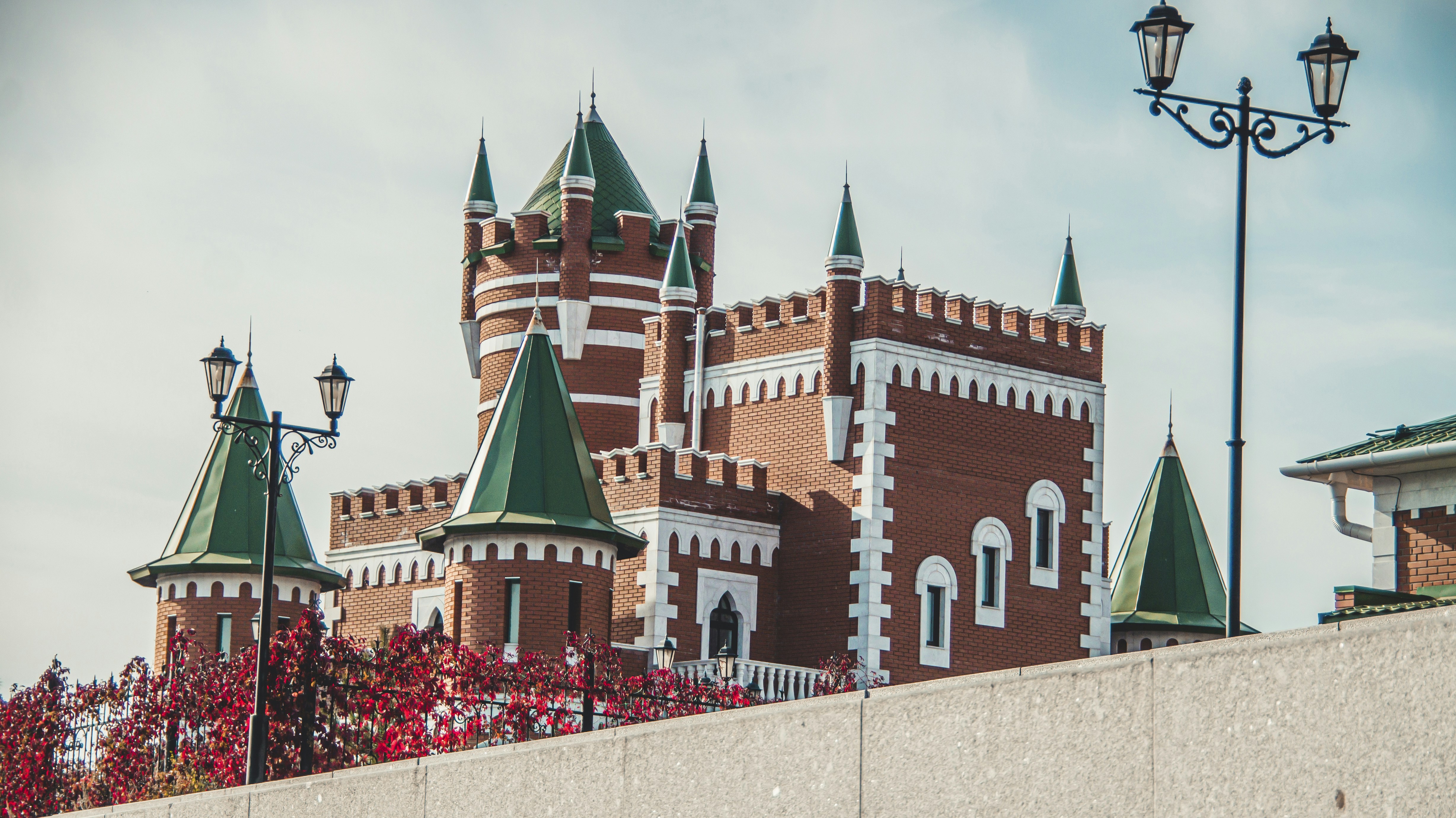 a brick building with green steeples