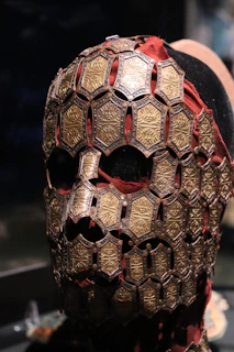 Close-up of handcrafted leather mask with subtle silver details on a dark background.