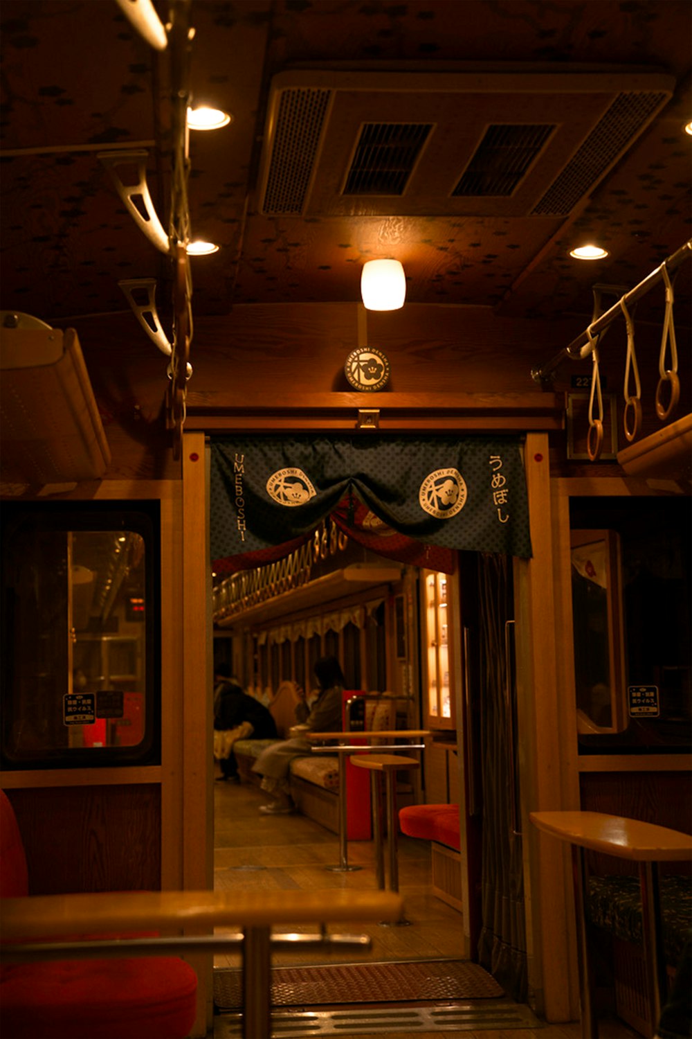 a restaurant with a bar and a couple people sitting at a table