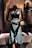 A sleek black leather corset set displayed on a mannequin with red leather accents.